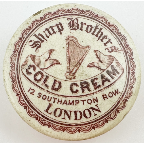 410 - LONDON COLD CREAM POT LID. (APL p388, 32) 2.6 ins diam. Red transfer large harp pict to centre decor... 