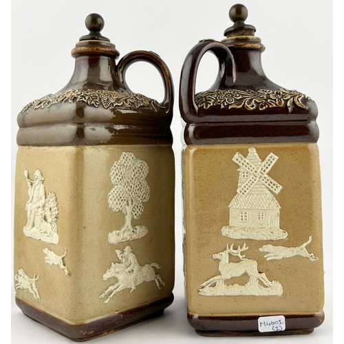 32 - SALT GLAZE DECANTERS DUO. Tallest 9.5ins. Heavily sprigged - hunting scene, windmills, rear handles ... 