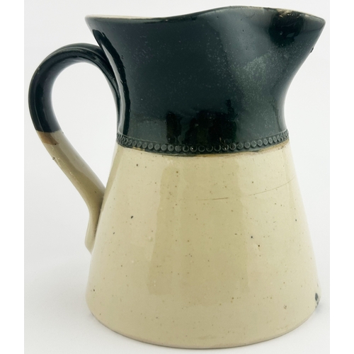 266 - STRAKERS WATER JUG. 5ins tall. Green top, black transfer. Price Bristol base p.m. Lip repair?