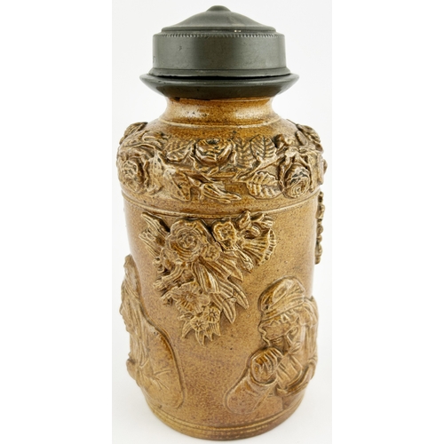 287 - SALT GLAZE LIDDED TOBACCO JAR. 7ins tall. Heavily sprigged with lady & flowers. Pewter screw lid.