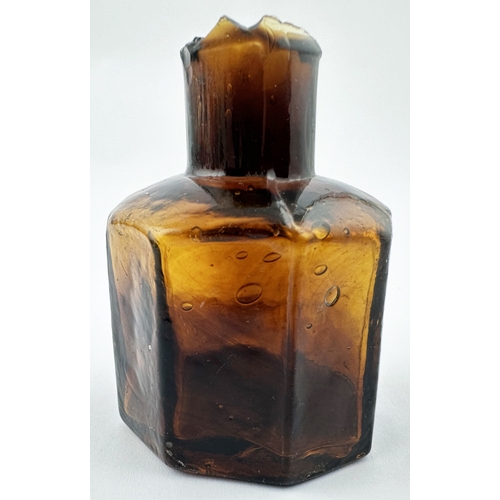 468 - AMBER OCTAGONAL INK BOTTLE WITH STRIATIONS. 2.25ins tall. An outstanding twist on a common octagonal... 