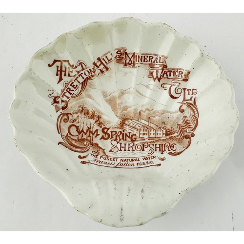 480 - SHROPSHIRE ADVERTISING DISH. 5 x 4.75ins. Shell shaped dish featuring burnt orange advertising to in... 