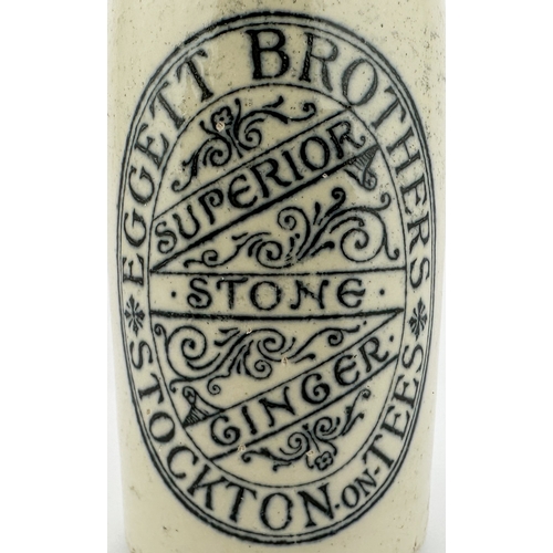 485 - STOCKTON ON TEES GINGER BEER BOTTLE. ??ins tall. Ch, t.t, blob lip. Decorative transfer EGGETT BROTH... 