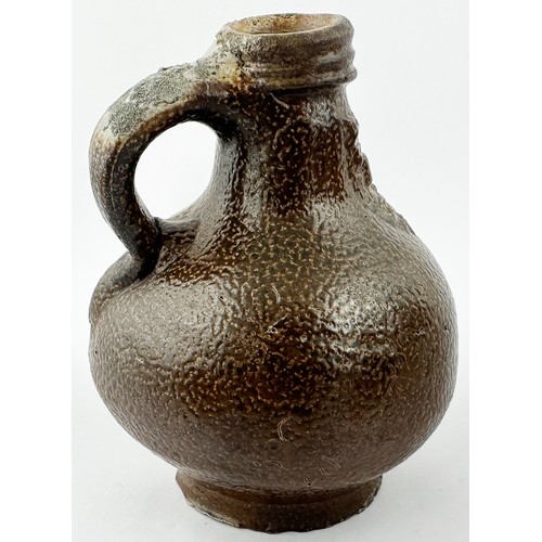 450 - BELLARMINE JUG. 5.25ins tall. A delightful, very rare, diminutive (small!) dark brown orange peel ef... 