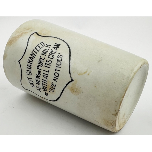70 - AS NEW OR PURE MILK BEAKER. 4.1ins tall. White with simple black transfer, shield saying NOT GUARANT... 