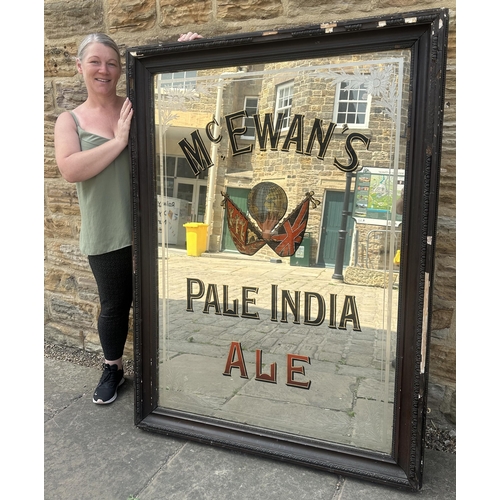 98 - MC EWENS PALE INDIA ALE FRAMED MIRROR. 59.5 x 44ins. Acid etched flowers to all four corners. Multi ... 