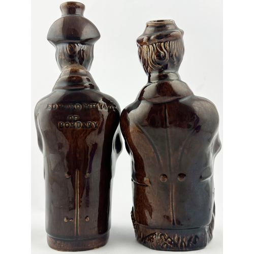 86 - EARTHENWARE SPIRIT FLASK DUO. Tallest 9.5ins. Treacle ware men sitting, one embossed to rear EDWARD ... 