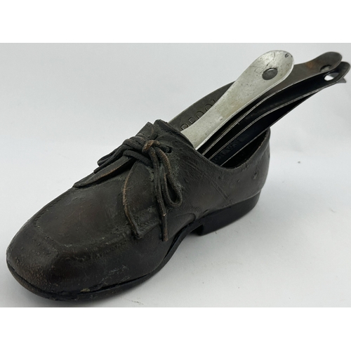 17 - SHOE HORNS & SAMPLE PIECE. Longest 5ins. Salesman type sample of a shoe with impressed shoe horns. L... 