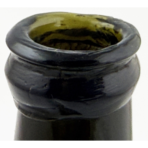 375 - LADIES LEG WINE BOTTLE. 10.2ins tall. Black glass, long slender ladies leg neck & sagged base. Form ... 