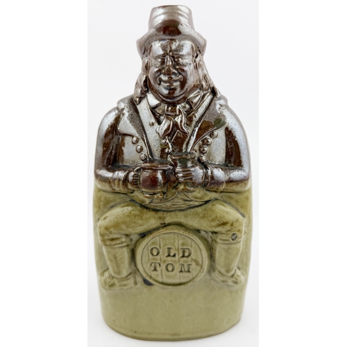 377 - OLD TOM REFORM FLASK. RF p32. 8.5ins tall. Grey-green glaze flask modelled as a toper sitting astrid... 