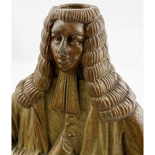 377 - OLD TOM REFORM FLASK. RF p32. 8.5ins tall. Grey-green glaze flask modelled as a toper sitting astrid... 