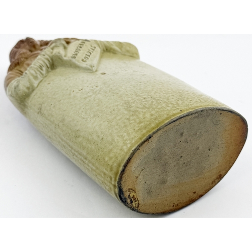 377 - OLD TOM REFORM FLASK. RF p32. 8.5ins tall. Grey-green glaze flask modelled as a toper sitting astrid... 