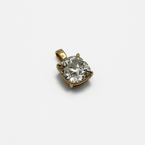 1 - An 18 carat gold mounted diamond pendant. The diamond cushion shaped, old brilliant cut, estimated a... 