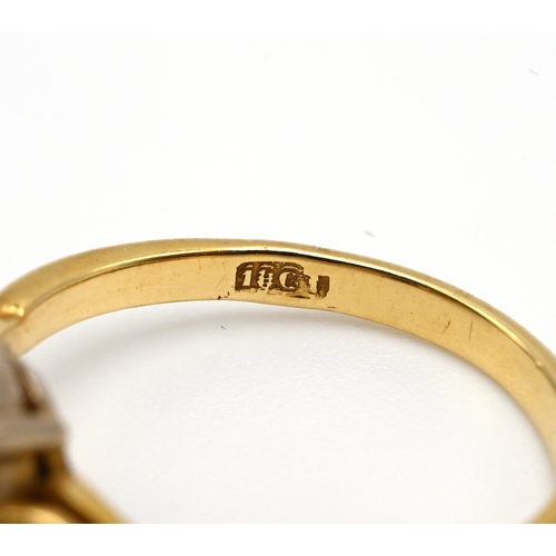 107 - An 18 carat gold garnet and diamond dress ring, finger size N, 3.9 grams gross.