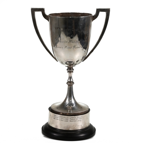 123 - A silver two handled trophy cup, inscribed, on a ‘silver’ mounted plastic base, weight of weighable ... 