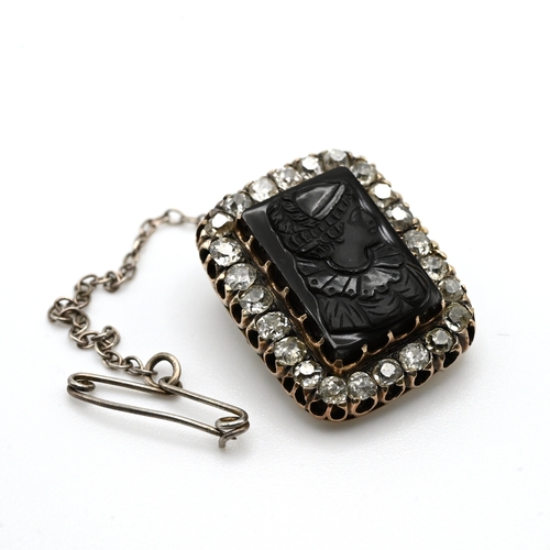 13 - A carved black onyx cameo and diamond brooch, circa 1900, the onyx measuring 1.7cm by 1.1cm, enclose... 