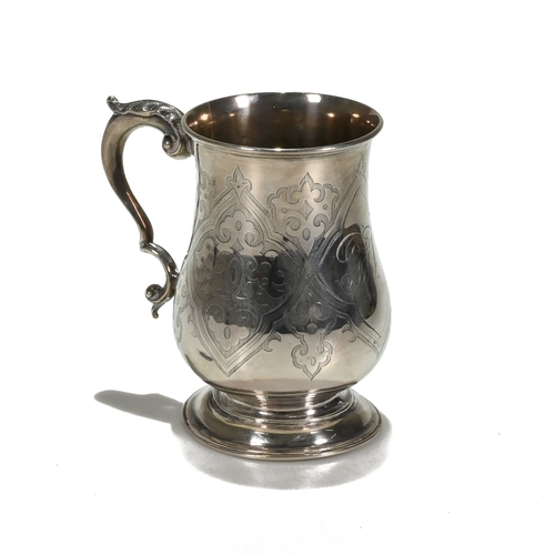 130 - A Victorian silver mug, Henry Holland, London 1867, with strap work cartouches and leaf decoration, ... 