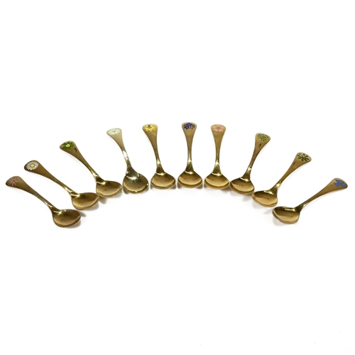 135 - A collection of nine Georg Jensen gilded and enamel Year Spoons, stamped marks, for the years 1975, ... 