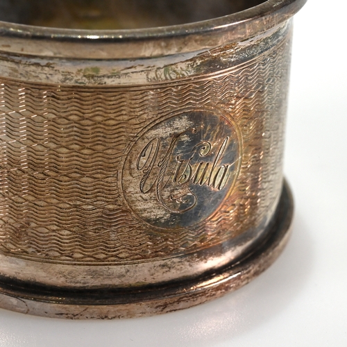 141 - A cased pair of Victorian silver napkin rings, Aldwinkle & Slater, London, 1885; with a cased silver... 