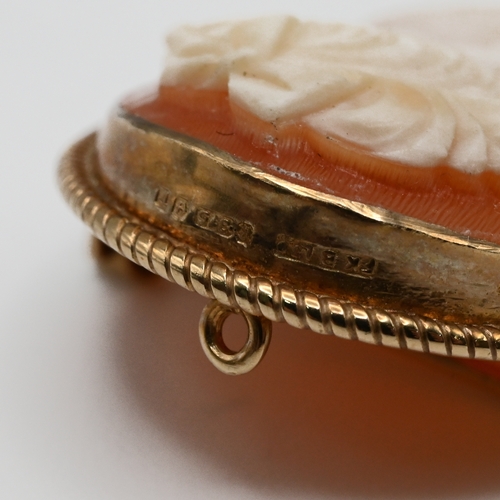 15 - A shell cameo brooch in a mount stamped ‘9kt’; with another smaller 9 carat gold mounted cameo brooc... 