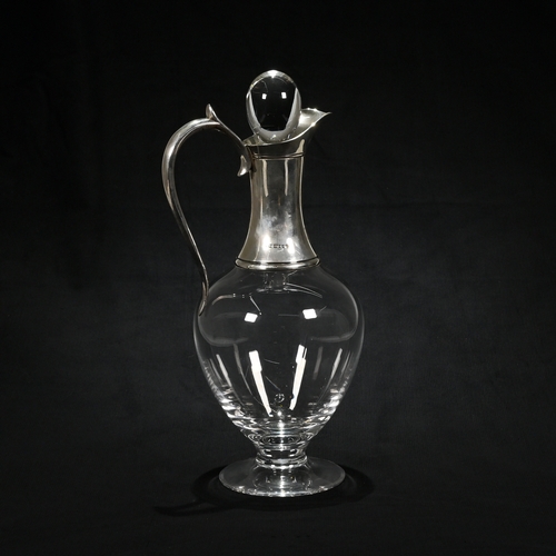 151 - A silver mounted glass claret jug, maker ‘JA”, London 2000, with stopper, 31 cm high.