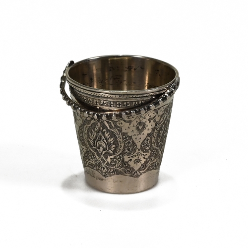 168 - A Turkish small beaker with a swing handle, stamped marks, 5 cm high excluding the handle.