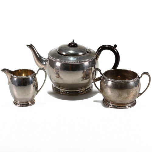 200 - A three piece silver tea service, Elkington & Co, Birmingham 1935, of circular form with dot and das... 