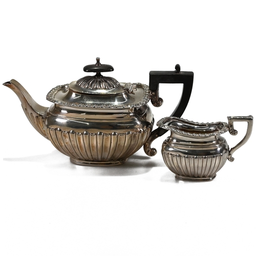 203 - A late Victorian silver teapot and cream jug, Deakin & Deakin, Chester 1898, of rounded rectangular ... 