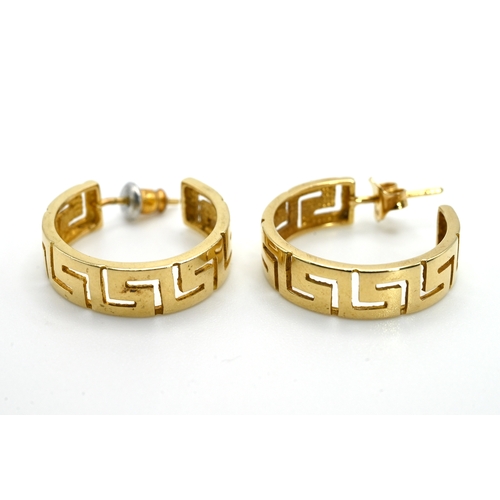 24 - A pair of hoop earrings, pierced with a Greek Key pattern, stamped ‘585’, 5.5 grams gross.