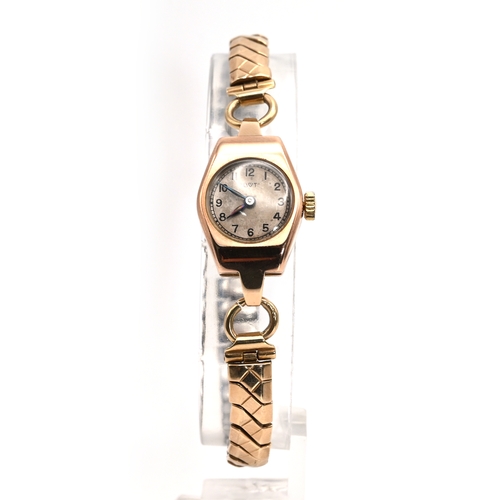 243 - Dot, a lady’s 9 carat gold mechanical wrist watch on a metal expanding bracelet. 