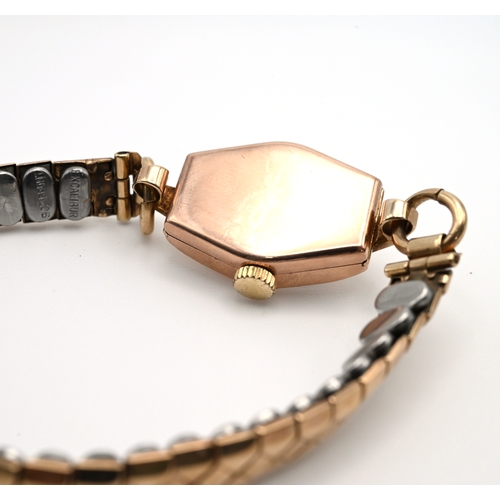 243 - Dot, a lady’s 9 carat gold mechanical wrist watch on a metal expanding bracelet. 