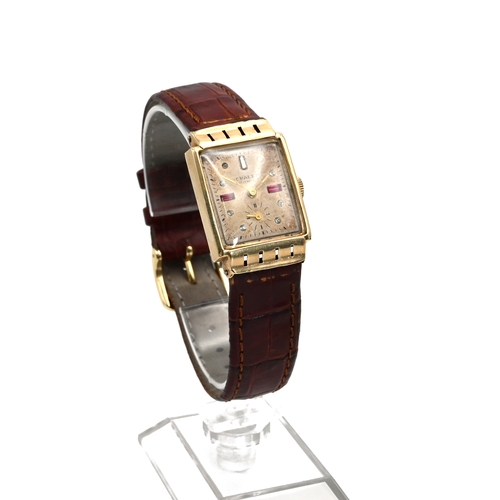 244 - Chalet, a gentleman’s 1940s mechanical wrist watch, stamped ’14k’, the rectangular dial set with red... 