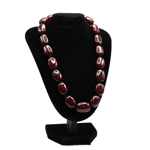 30 - A row of oval dark cherry amber style beads necklace, 61 grams. 