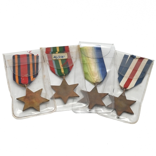 398 - A group of four World War Two star medals to include: The Atlantic Star, The Pacific Star, The Burma... 