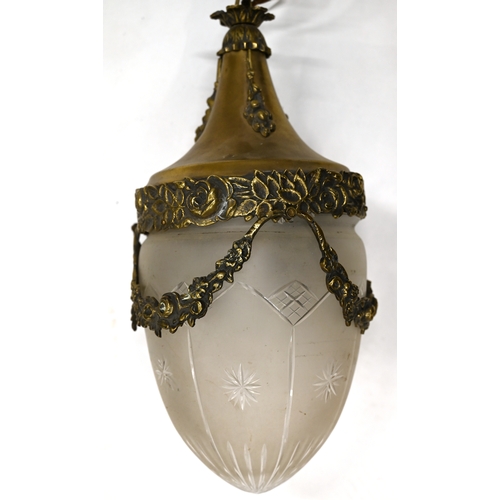 443 - A well cast brass and glass ceiling lamp which dates to the early 20th Century. Cast brass body and ... 