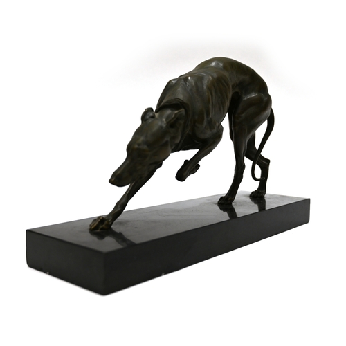 471 - A well patinated bronze study of a prowling Greyhound, finely figured, on a rectangular marble base.... 