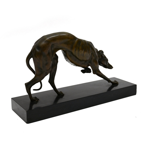 471 - A well patinated bronze study of a prowling Greyhound, finely figured, on a rectangular marble base.... 