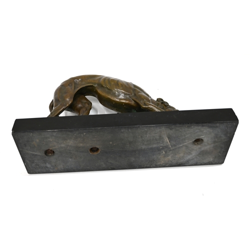 471 - A well patinated bronze study of a prowling Greyhound, finely figured, on a rectangular marble base.... 