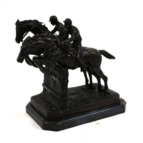 477 - A dark brown patinated bronze sculpture of two racing horses and their jockeys taking a fence in a s... 