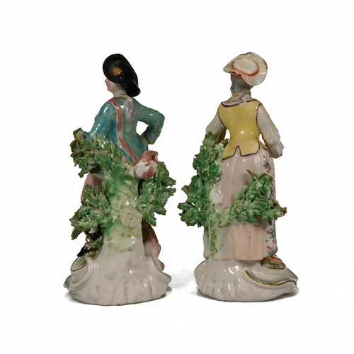 497 - A hand painted 18th century porcelain shepherd and shepherdess, possibly Derby. The shepherdess and ... 