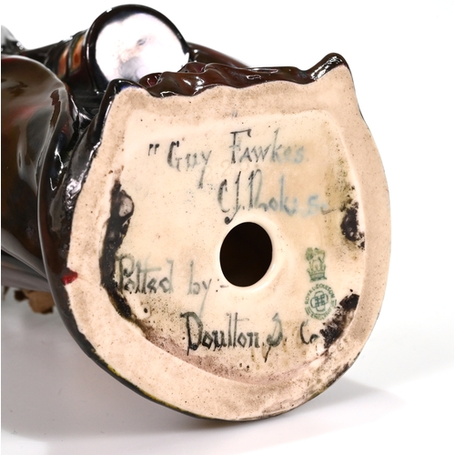 504 - Guy Fawkes figurine bearing the signature Charles Noke Sc and the painted words Potted by Doulton & ... 