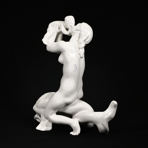 506 - A Mid 20th Century Bing & Grondahl figurine depicting a nude female sitting astride a dolphin, raisi... 