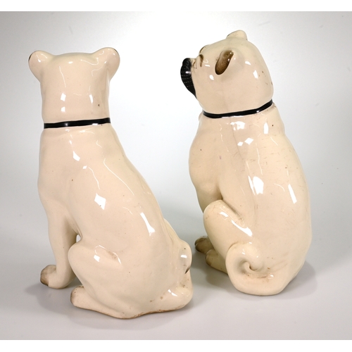 509 - A pair of Staffordshire pottery Pug dogs. Legs free, white bodies, black muzzle and collar, red mout... 