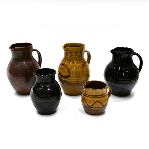 517 - A quantity of Cricklade pottery, to include 4 jugs and 1 vase. The vase with black ground and sgraff... 