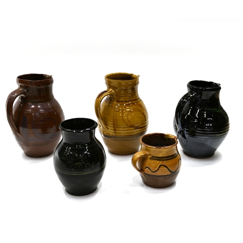 517 - A quantity of Cricklade pottery, to include 4 jugs and 1 vase. The vase with black ground and sgraff... 