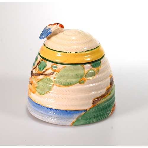 521 - A Clarice Cliff 'Beehivehoney pot secrets pattern with a tree and cottages in coastal landscape with... 