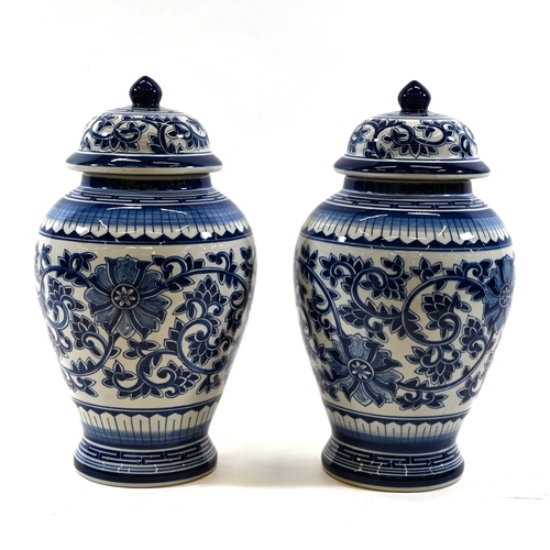 522 - A pair of large baluster Blue and White Temple jars with lids. Flower and vine decoration. Dimension... 