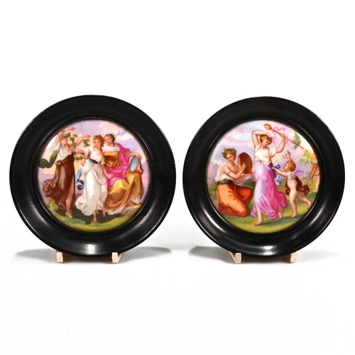 527 - A pair of circular Victorian hand painted porcelain plaques, one depicting the Three Graces, the oth... 