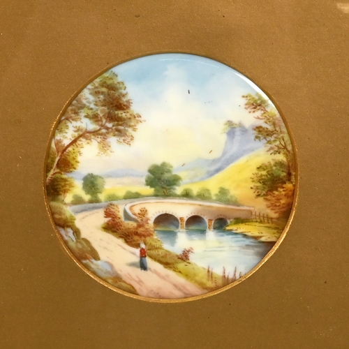 528 - A pair of 19th Century circular ceramic plaques (8.7cm diameter) each painted with landscape scenes,... 