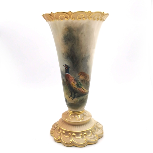 549 - A Royal Worcester blush ivory trumpet vase hand painted with pheasants in a landscape by James Stint... 